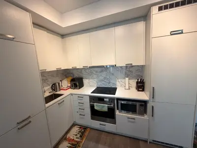 a white kitchen with white cabinets and appliances at Uniqueplace in Vaughan