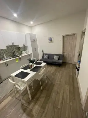 a kitchen and a living room with a table and chairs at Central Downtown New Year Stay- Self Checkin & Free Wifi in Toronto