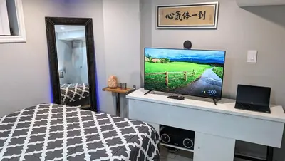 a bedroom with a bed and a television on a desk at Room Ideal for Knowledge Workers in Toronto