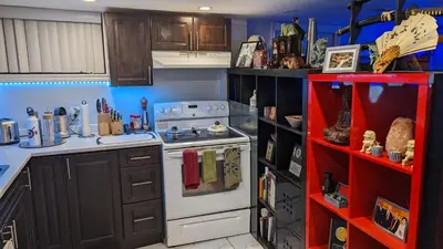 a kitchen with a white stove and a red shelf at Room Ideal for Knowledge Workers in Toronto