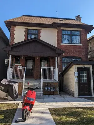 a red scooter parked in front of a house at Room Ideal for Knowledge Workers in Toronto