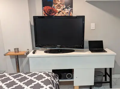 a computer monitor on a white desk in a room at Room Ideal for Knowledge Workers in Toronto