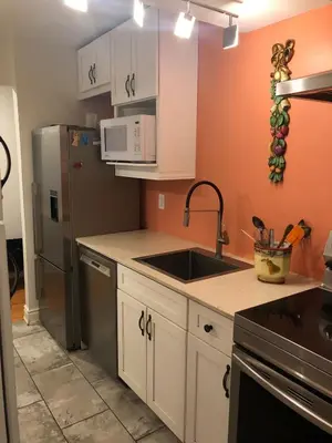 a kitchen with a sink and a refrigerator at Hamilton condo, close to Toronto and Niagara Falls in Hamilton