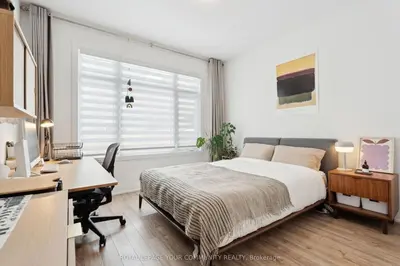 a bedroom with a bed and a desk and a desk at North City Haven - Cozy 2 Bedroom Retreat in Barrie