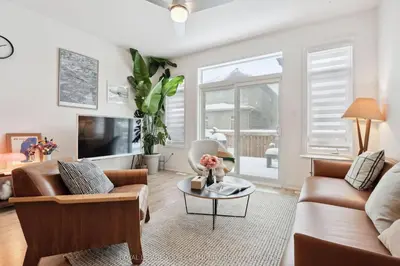a living room with a couch and a table at North City Haven - Cozy 2 Bedroom Retreat in Barrie