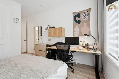 a bedroom with a desk with a computer and a bed at North City Haven - Cozy 2 Bedroom Retreat in Barrie