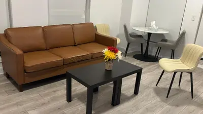 a living room with a couch and a table and chairs at Trafalgar in Oakville
