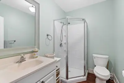 a bathroom with a shower and a toilet and a sink at Crystal Beach Stunning Waterfront Stay with Fire Pit in Fort Erie