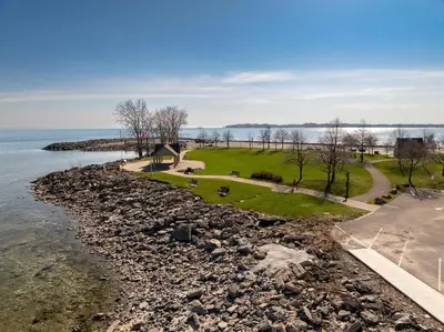 a small island in the middle of the water at Crystal Beach Stunning Waterfront Stay with Fire Pit in Fort Erie