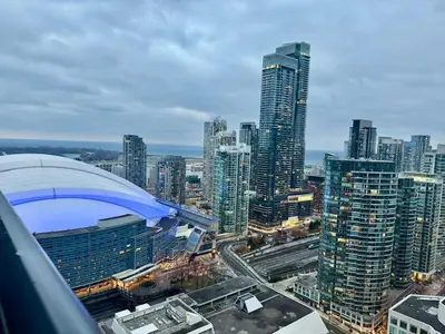 a view of a large city with tall buildings at CN Tower and Rogers Centre View and Central Island Lake View in Toronto