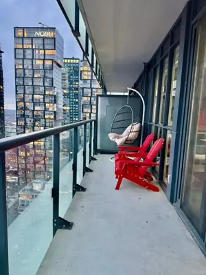 a swing on the balcony of a building at CN Tower and Rogers Centre View and Central Island Lake View in Toronto