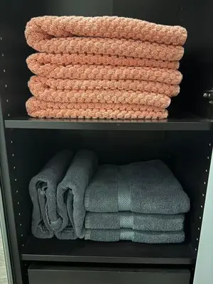 a group of towels are sitting on a shelf at CN Tower and Rogers Centre View and Central Island Lake View in Toronto