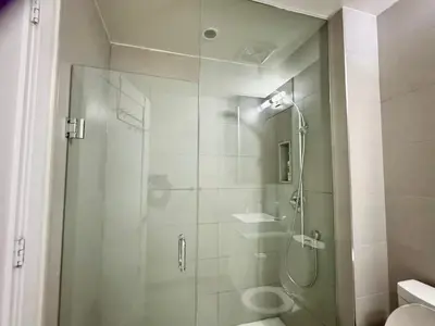 a bathroom with a shower with a glass door at CN Tower and Rogers Centre View and Central Island Lake View in Toronto