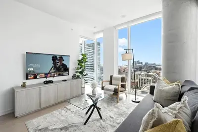 a living room with a tv and a large window at Luxury Downtown Stay with Spacious Patio in Toronto