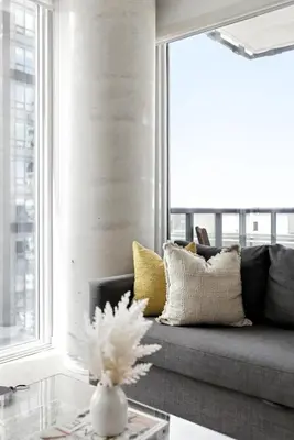 a living room with a couch and a window at Luxury Downtown Stay with Spacious Patio in Toronto