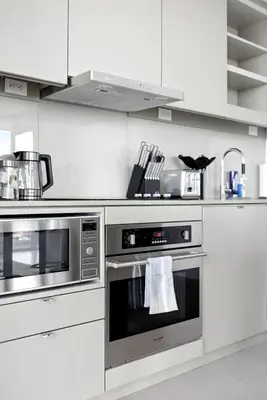 a kitchen with stainless steel ovens in a white kitchen at Luxury Downtown Stay with Spacious Patio in Toronto