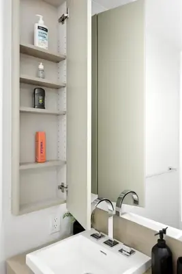 a bathroom with a sink and a mirror at Luxury Downtown Stay with Spacious Patio in Toronto