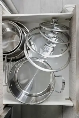 a bunch of plates and pans in a drawer at Modern Downtown Retreat 3BR Condo with Patio in Toronto