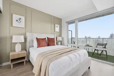 a bedroom with a large bed and a large window at Cozy 1BR Suite Steps to Subway City Views in Toronto