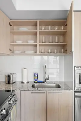 a kitchen with a sink and a counter top at Cozy 1BR Suite Steps to Subway City Views in Toronto