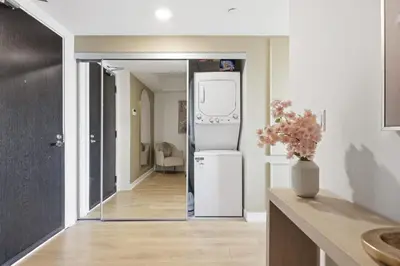 a kitchen with a refrigerator and a hallway at Cozy 1BR Suite Steps to Subway City Views in Toronto