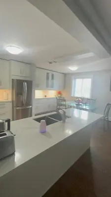 a kitchen with a white counter top in a room at Luxurious Two Bedroom Apartment in Burlington