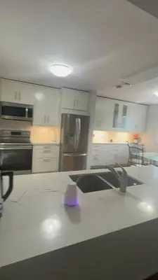 a kitchen with a counter with a purple candle on it at Luxurious Two Bedroom Apartment in Burlington