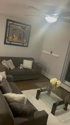 a living room with a couch and a table at Luxurious Two Bedroom Apartment in Burlington