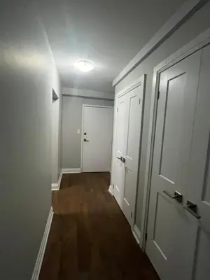 an empty room with a hallway with white doors at Luxurious Two Bedroom Apartment in Burlington