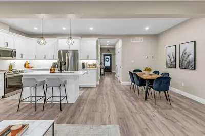a kitchen and dining room with a table and chairs at Cozy & Modern Home | EV Charger in Elmira