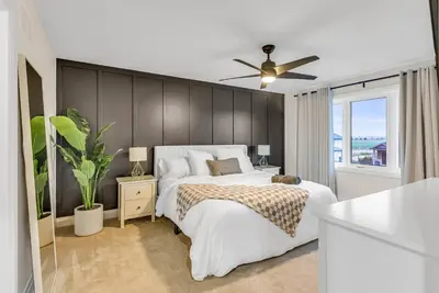 a bedroom with a bed and a ceiling fan at Cozy & Modern Home | EV Charger in Elmira