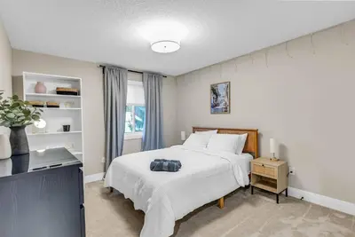 a bedroom with a bed and a television in it at Cozy & Modern Home | EV Charger in Elmira