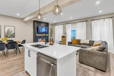 a kitchen and living room with a couch at Cozy & Modern Home | EV Charger in Elmira