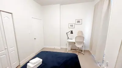 a white room with a desk and a chair at warm heart toronto in Toronto