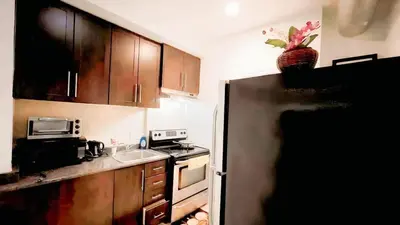 a kitchen with a stainless steel refrigerator and a sink at warm heart toronto in Toronto