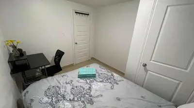 a small room with a bed and a desk at warm heart toronto in Toronto