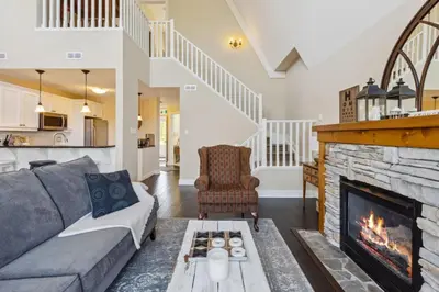 a living room with a couch and a fireplace at 225 Snowbridge with Village Shuttle in Blue Mountains