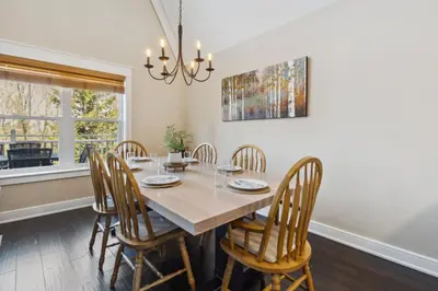 a dining room with a table and chairs at 225 Snowbridge with Village Shuttle in Blue Mountains