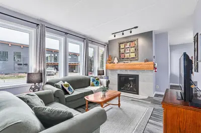 a living room with two couches and a fireplace at 2BDR Condo Steps to Blue Mountain Village - 101 Cachet Crossing in Blue Mountains