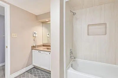 a bathroom with a white tub and a sink at 2BDR Condo Steps to Blue Mountain Village - 101 Cachet Crossing in Blue Mountains