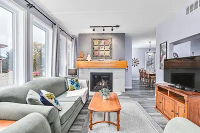 a living room with a couch and a fireplace at 2BDR Condo Steps to Blue Mountain Village - 101 Cachet Crossing in Blue Mountains