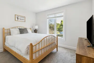 a bedroom with a bed and a window at Townhouse with Hot Tub near Blue Mountain Village - 162 Vacation Inn in Collingwood