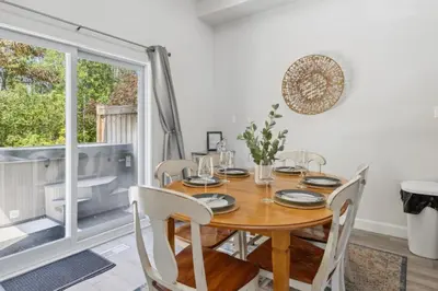 a dining room with a wooden table and chairs at Townhouse with Hot Tub near Blue Mountain Village - 162 Vacation Inn in Collingwood
