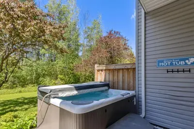 a hot tub sitting outside of a house at Townhouse with Hot Tub near Blue Mountain Village - 162 Vacation Inn in Collingwood