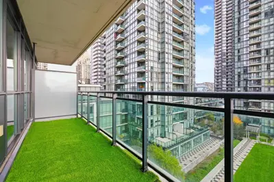 a balcony with green grass in a building at Stylish Downtown - Condo Sleeps 8 - YYZ Airport in Mississauga