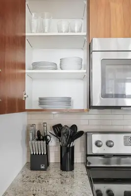 a kitchen counter with plates and utensils in an oven at Stylish Downtown - Condo Sleeps 8 - YYZ Airport in Mississauga