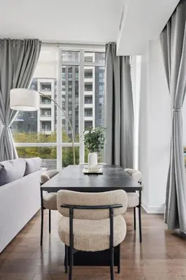 a dining room with a black table and chairs at Sleek Sq 1 Downtown Condo - 4 beds - Parking in Mississauga