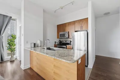 a kitchen with a sink and a refrigerator at Sleek Sq 1 Downtown Condo - 4 beds - Parking in Mississauga