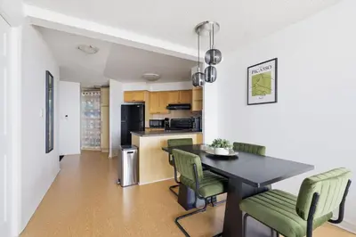a kitchen and dining room with a table and chairs at Stylish 2br High-Rise - Sleeps 7 - YYZ in Mississauga