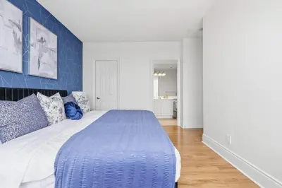 a blue and white bedroom with a large bed at Stylish 3br Condo - Parking - 65 TV in Mississauga